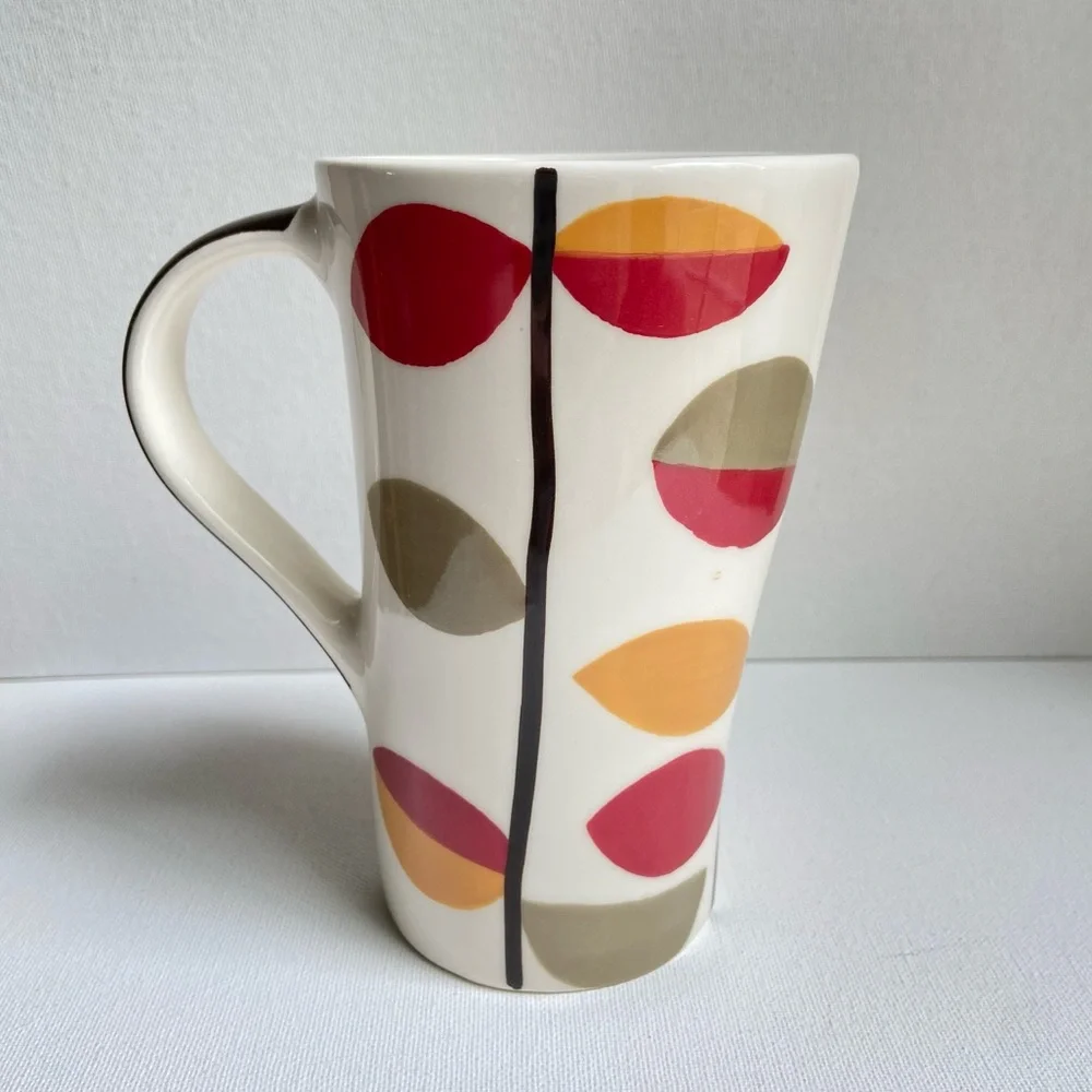 Pier 1 tall asymmetrical oval coffee mug with abstract fall leaves and stripes